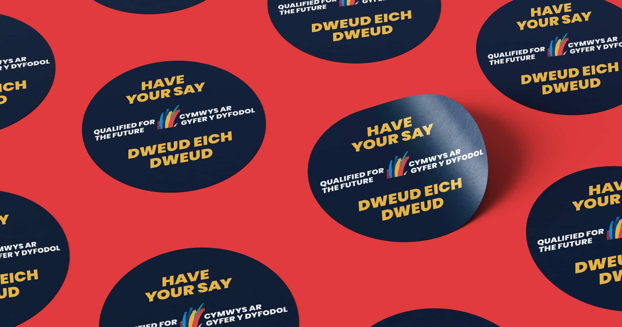 Red background with overlapping circular stickers in navy blue, each featuring the slogan 'Have Your Say' in bold white letters and the bilingual 'Qualified for the Future' logo in English and Welsh.