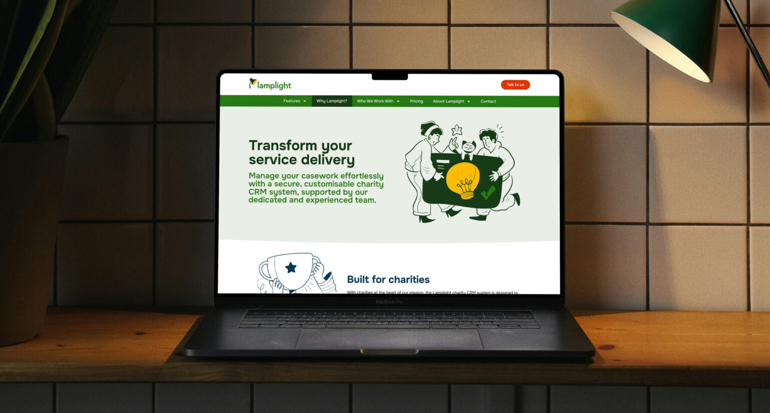Laptop displaying Lamplight website interface with modern, accessible design