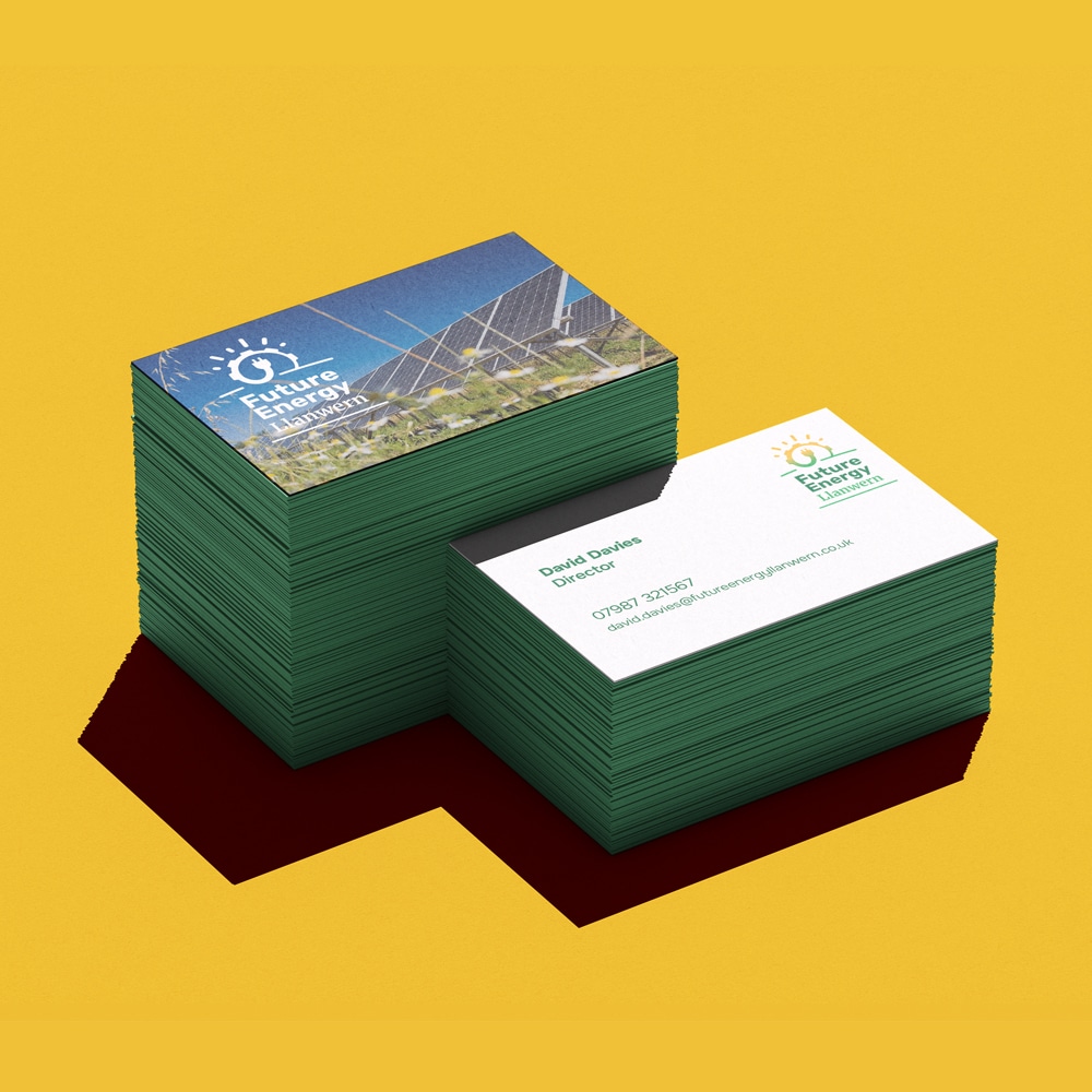 Stacked business cards for 'Future Energy Llanwern', featuring a solar panel image on the front side and contact details on the reverse with a green edge design.