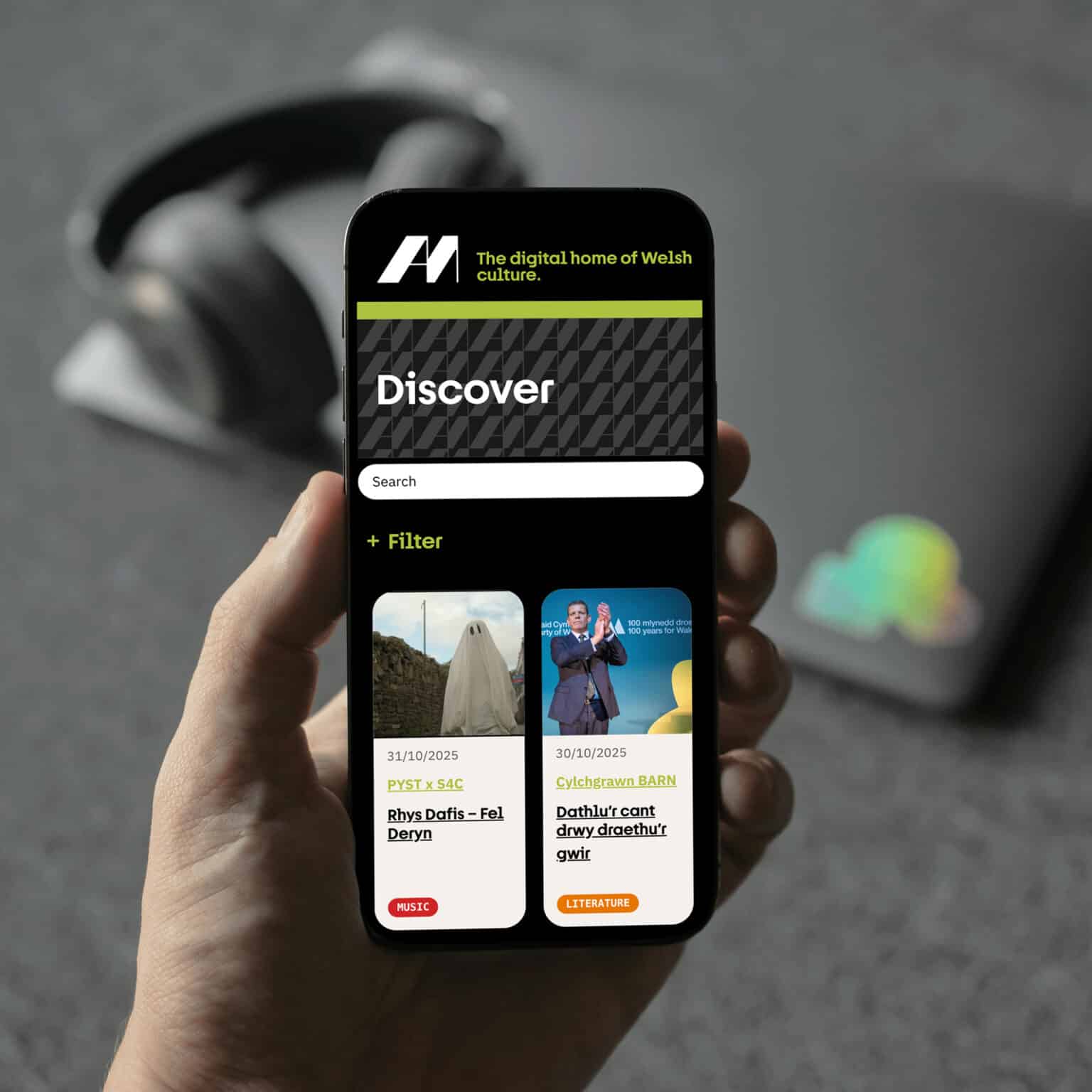 Am bilingual WordPress website on mobile showing the Discover page and filters; responsive web design and development by Design Tribe, Wales.